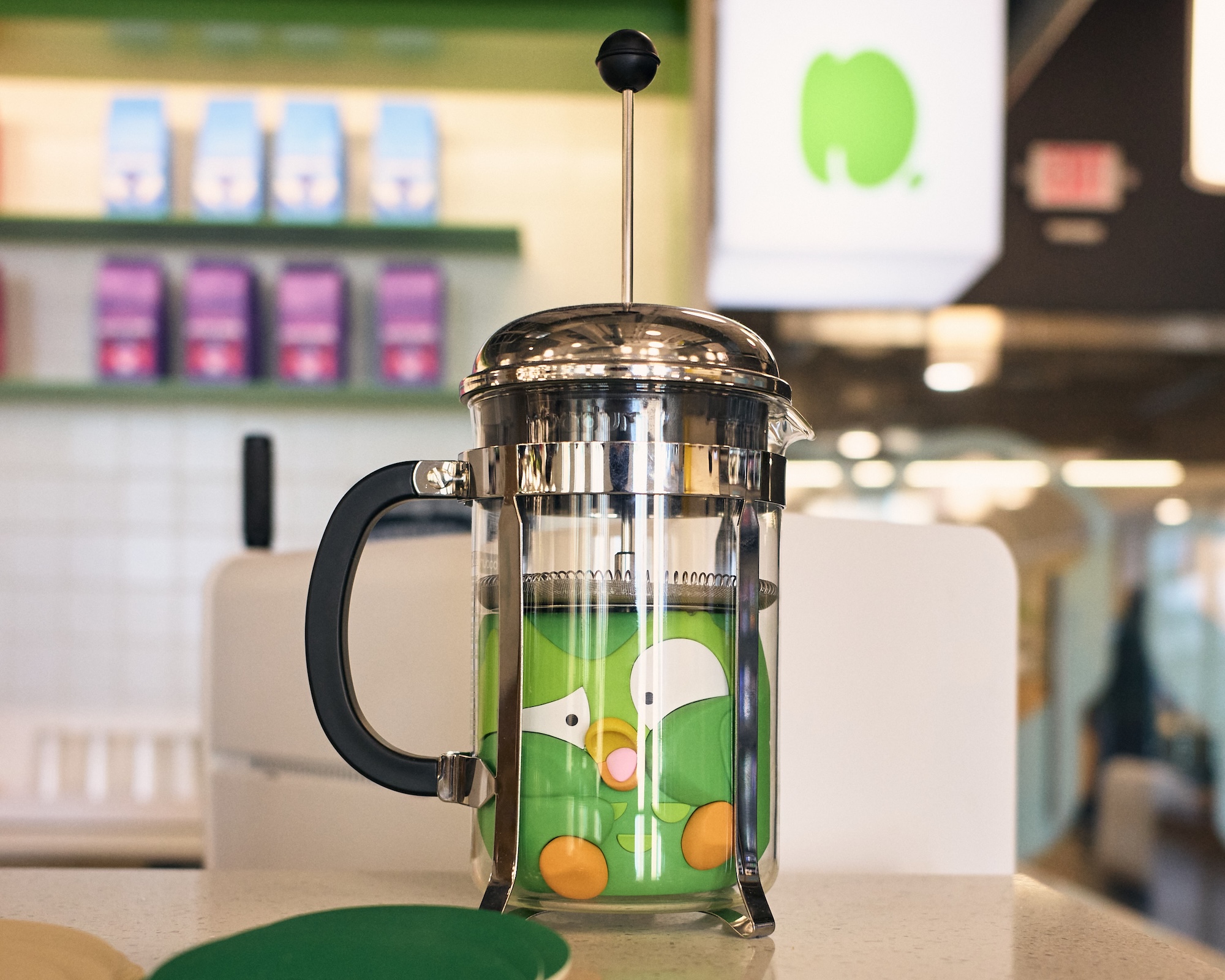 A toy Duo getting squashed inside of a french press as if he's supposed to be the coffee